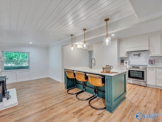 1901 Governors Dr SE, Huntsville, AL 35801 - kitchen featuring electric range, light countertops, custom exhaust hood, crown molding, and white cabinets