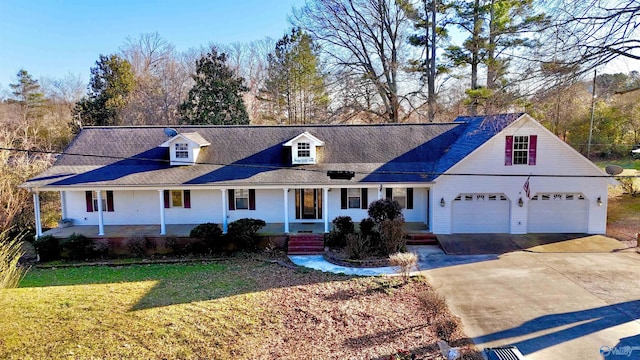 view of front of home featuring a front yard, a garage, covered porch, and driveway