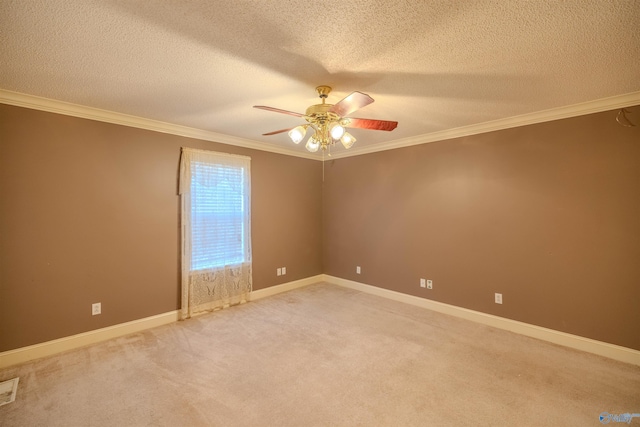 empty room with a ceiling fan, baseboards, a textured ceiling, crown molding, and light colored carpet