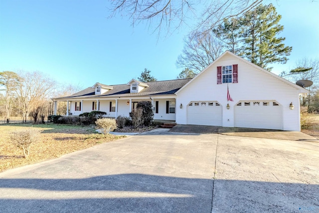 view of front of home featuring covered porch, driveway, and a garage