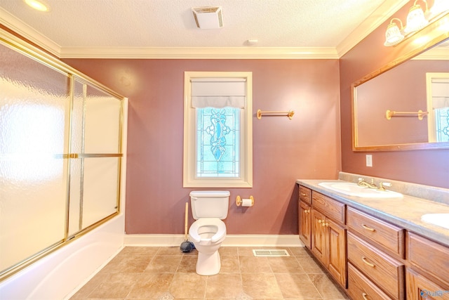 full bathroom with crown molding, toilet, visible vents, and a sink