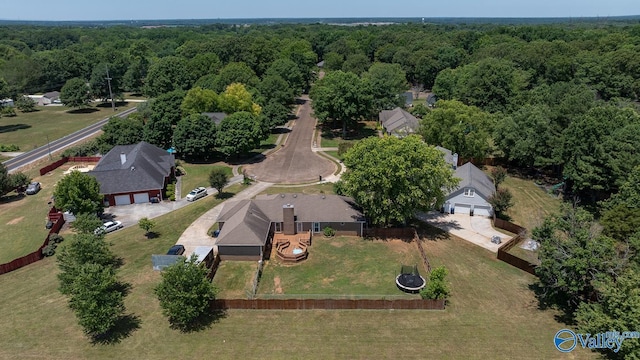birds eye view of property featuring a wooded view