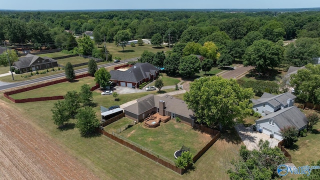 drone / aerial view featuring a wooded view