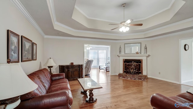 565 Joe Quick Rd, Hazel Green, AL 35750 - living room with a tray ceiling, a ceiling fan, ornamental molding, wood finished floors, and a fireplace