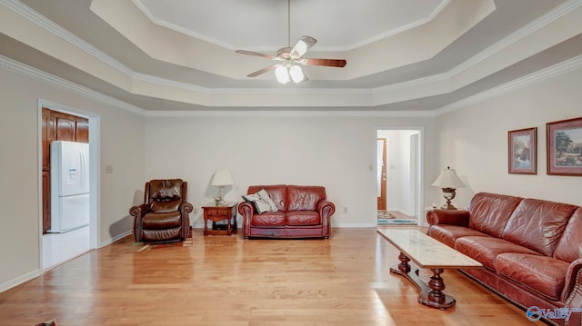 565 Joe Quick Rd, Hazel Green, AL 35750 - living area with light wood-style flooring, a raised ceiling, ceiling fan, ornamental molding, and baseboards