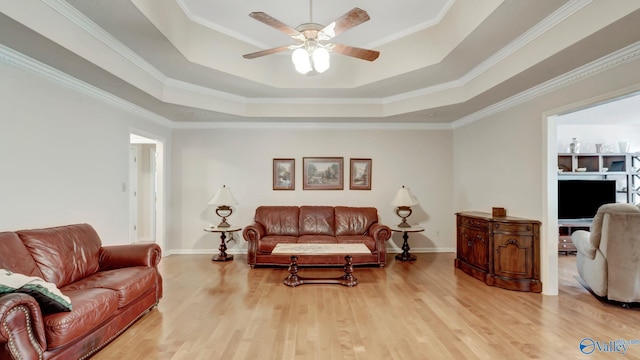 565 Joe Quick Rd, Hazel Green, AL 35750 - living room with a tray ceiling, a ceiling fan, light wood-style flooring, crown molding, and baseboards