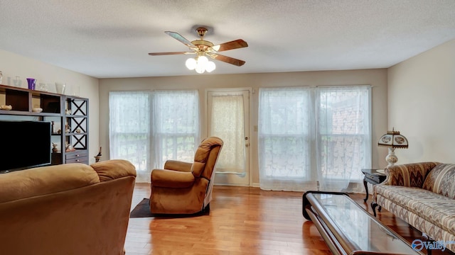 565 Joe Quick Rd, Hazel Green, AL 35750 - living area with light wood-style floors, a textured ceiling, and a ceiling fan