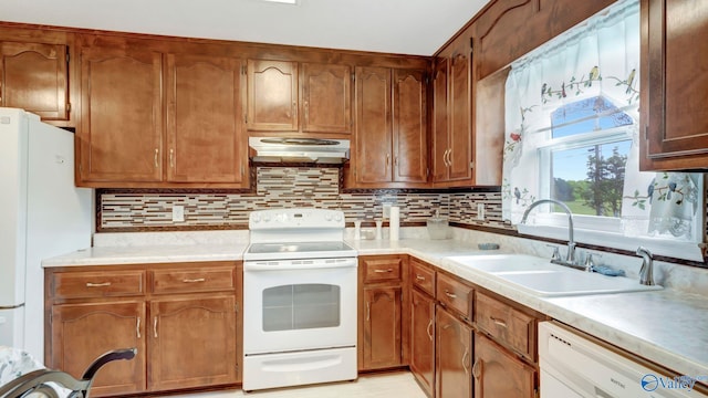 565 Joe Quick Rd, Hazel Green, AL 35750 - kitchen with white appliances, under cabinet range hood, a sink, backsplash, and light countertops