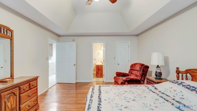 565 Joe Quick Rd, Hazel Green, AL 35750 - bedroom featuring light wood-style floors, ensuite bathroom, a raised ceiling, baseboards, and ceiling fan