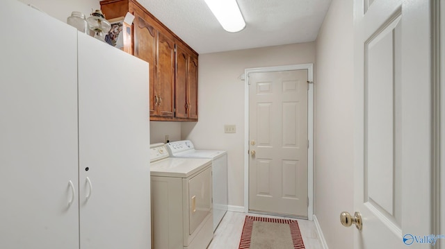 565 Joe Quick Rd, Hazel Green, AL 35750 - clothes washing area with washing machine and clothes dryer, cabinet space, baseboards, and light tile patterned floors