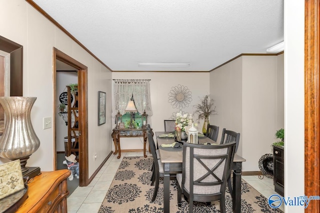 dining space featuring a textured ceiling, crown molding, and light tile patterned floors