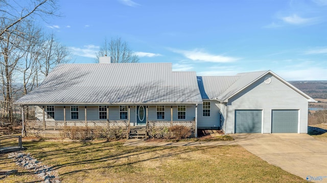 view of front of property featuring a garage, a front yard, and a porch