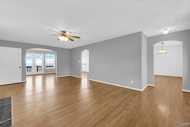 unfurnished living room with light hardwood / wood-style flooring and ceiling fan