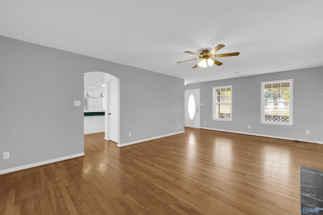 unfurnished living room featuring ceiling fan and hardwood / wood-style floors