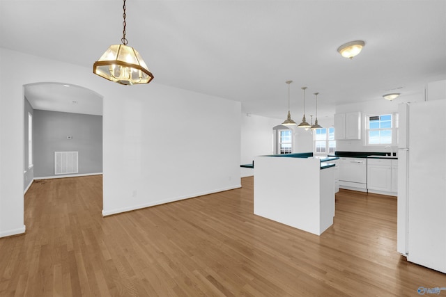 kitchen featuring pendant lighting, white appliances, white cabinets, and light hardwood / wood-style flooring