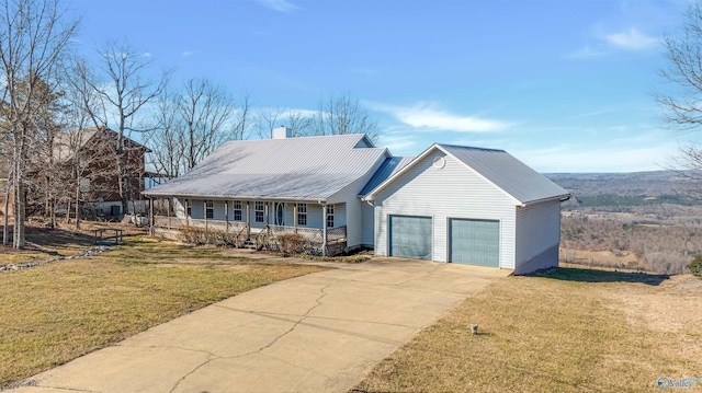 view of front of property featuring a porch, a garage, and a front lawn