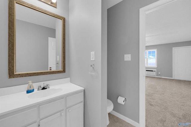 bathroom with vanity, toilet, and a wall mounted air conditioner