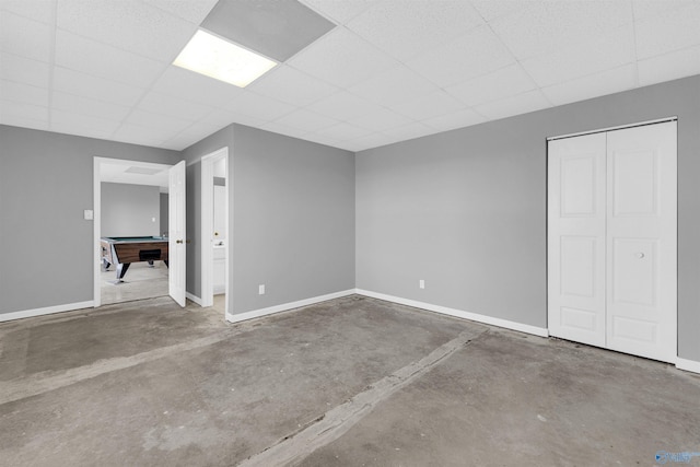 basement featuring pool table and a drop ceiling