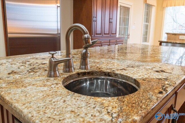 interior details featuring sink and stainless steel refrigerator