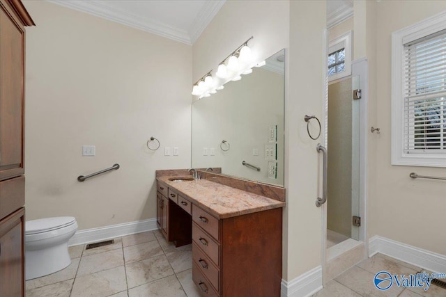 bathroom with tile patterned floors, vanity, toilet, walk in shower, and crown molding