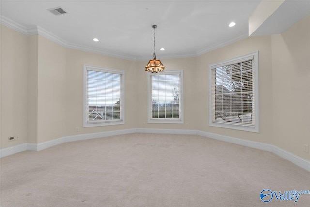 carpeted spare room featuring an inviting chandelier and crown molding