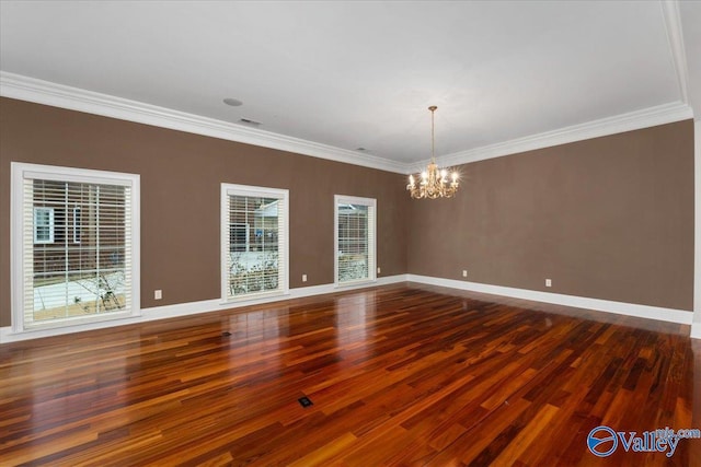 empty room with dark hardwood / wood-style flooring, an inviting chandelier, and ornamental molding