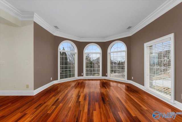 unfurnished room featuring ornamental molding and wood-type flooring