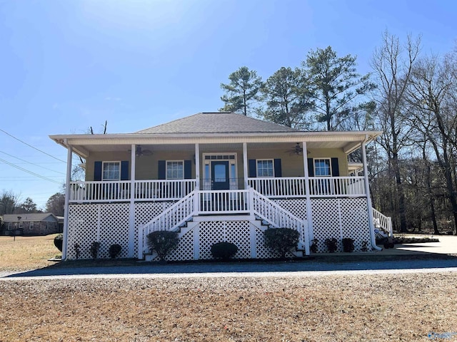 view of front of property featuring a shingled roof, stairs, a porch, and a ceiling fan