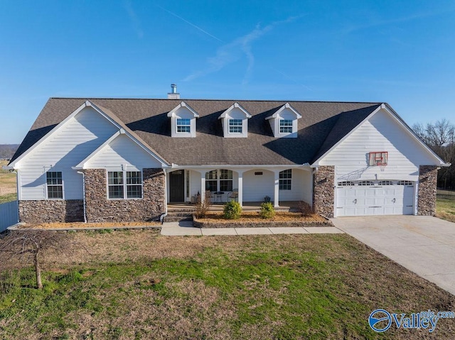 cape cod-style house featuring a garage, stone siding, a porch, and a front yard