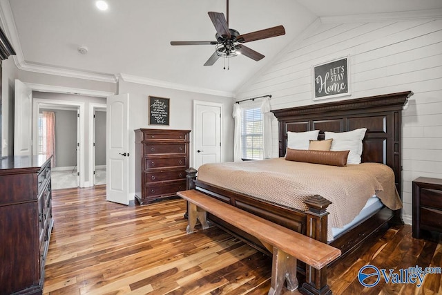 bedroom with lofted ceiling, ornamental molding, a ceiling fan, wood finished floors, and baseboards