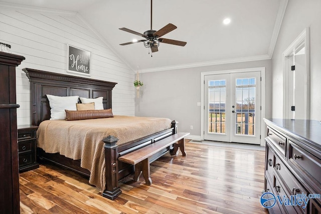 bedroom featuring lofted ceiling, ornamental molding, wood finished floors, access to outside, and french doors