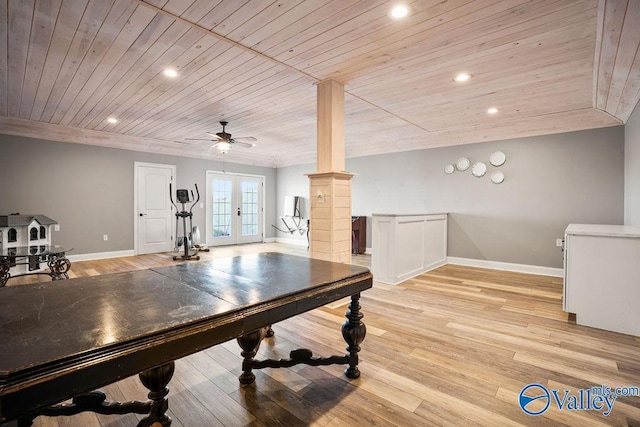 recreation room featuring french doors, decorative columns, light wood-style flooring, wood ceiling, and baseboards