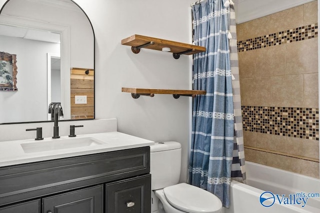 bathroom featuring toilet, shower / tub combo with curtain, and vanity