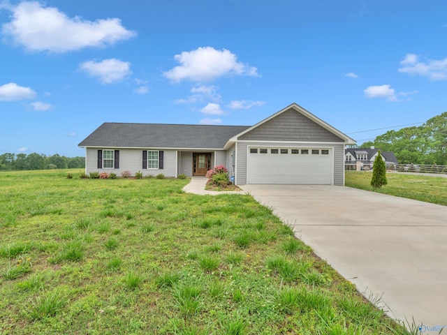 ranch-style home featuring a garage, a shingled roof, driveway, and a front yard
