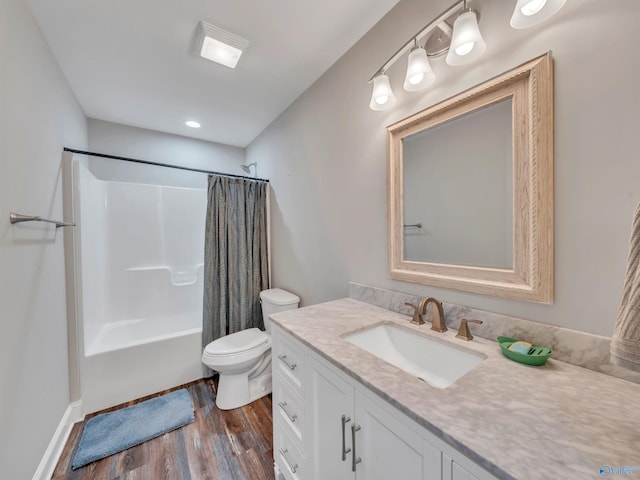 full bathroom featuring vanity, wood finished floors, toilet, and shower / bath combo with shower curtain