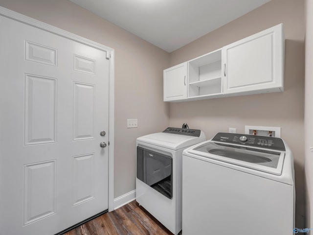 laundry room with cabinet space, baseboards, dark wood-style floors, and washing machine and clothes dryer