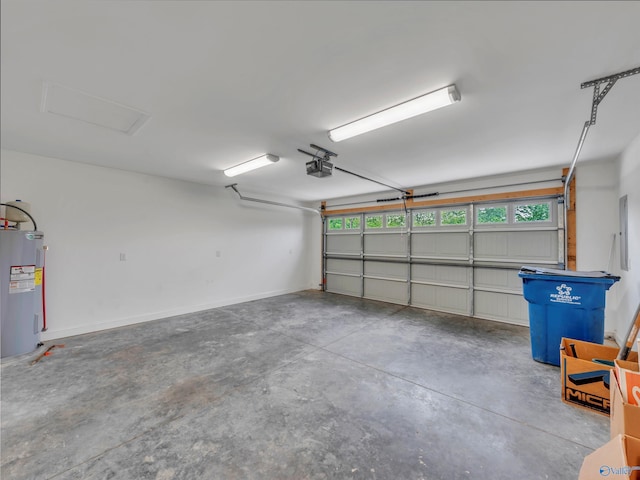 garage featuring baseboards, a garage door opener, and water heater
