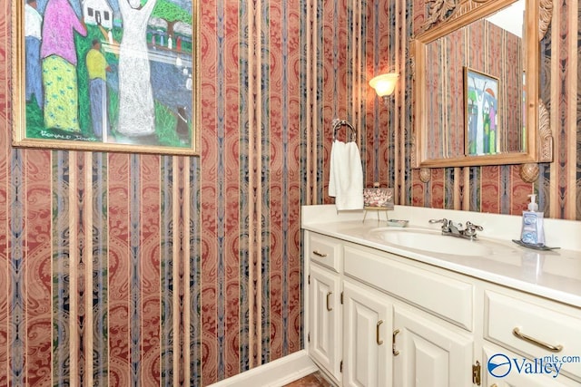 bathroom featuring vanity and wallpapered walls