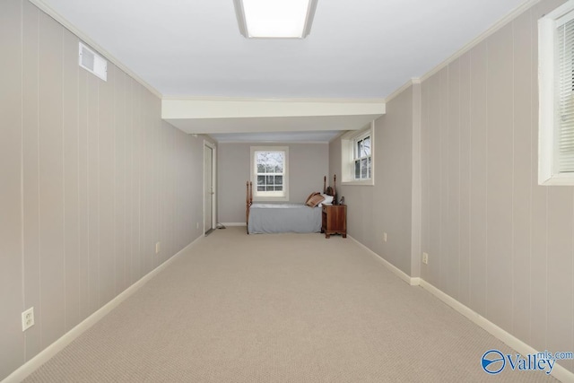 unfurnished bedroom with baseboards, visible vents, carpet flooring, and ornamental molding