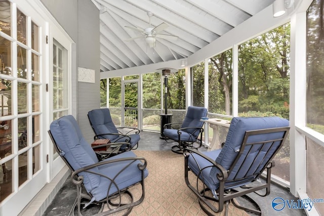 sunroom with ceiling fan and lofted ceiling with beams