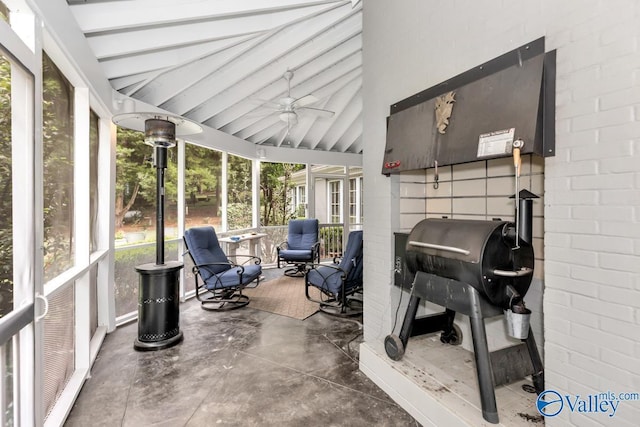 sunroom featuring vaulted ceiling with beams and a ceiling fan