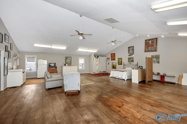 living area featuring visible vents, plenty of natural light, and hardwood / wood-style floors