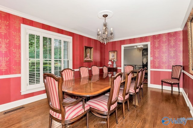 dining space featuring wood finished floors, visible vents, a notable chandelier, and wallpapered walls