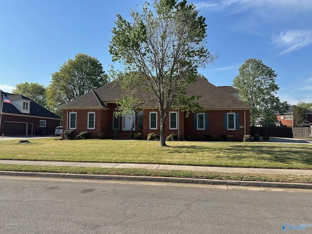 view of front of home with a front lawn and brick siding
