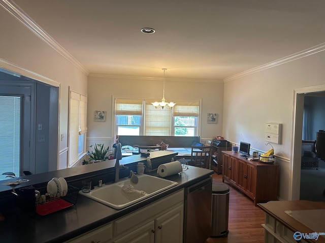 kitchen featuring a sink, ornamental molding, an inviting chandelier, and dishwasher