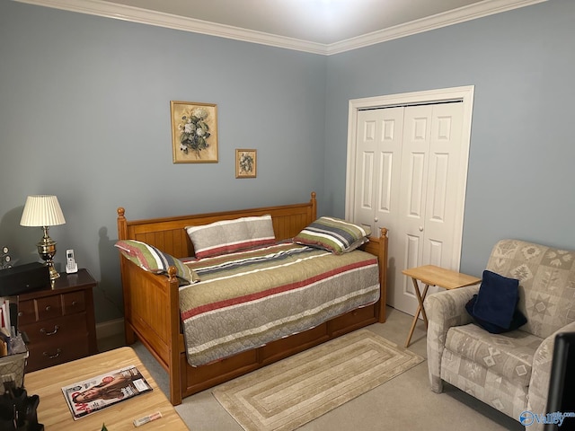 carpeted bedroom with ornamental molding and a closet