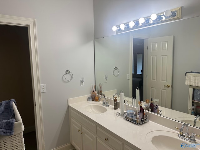 full bathroom with double vanity and a sink