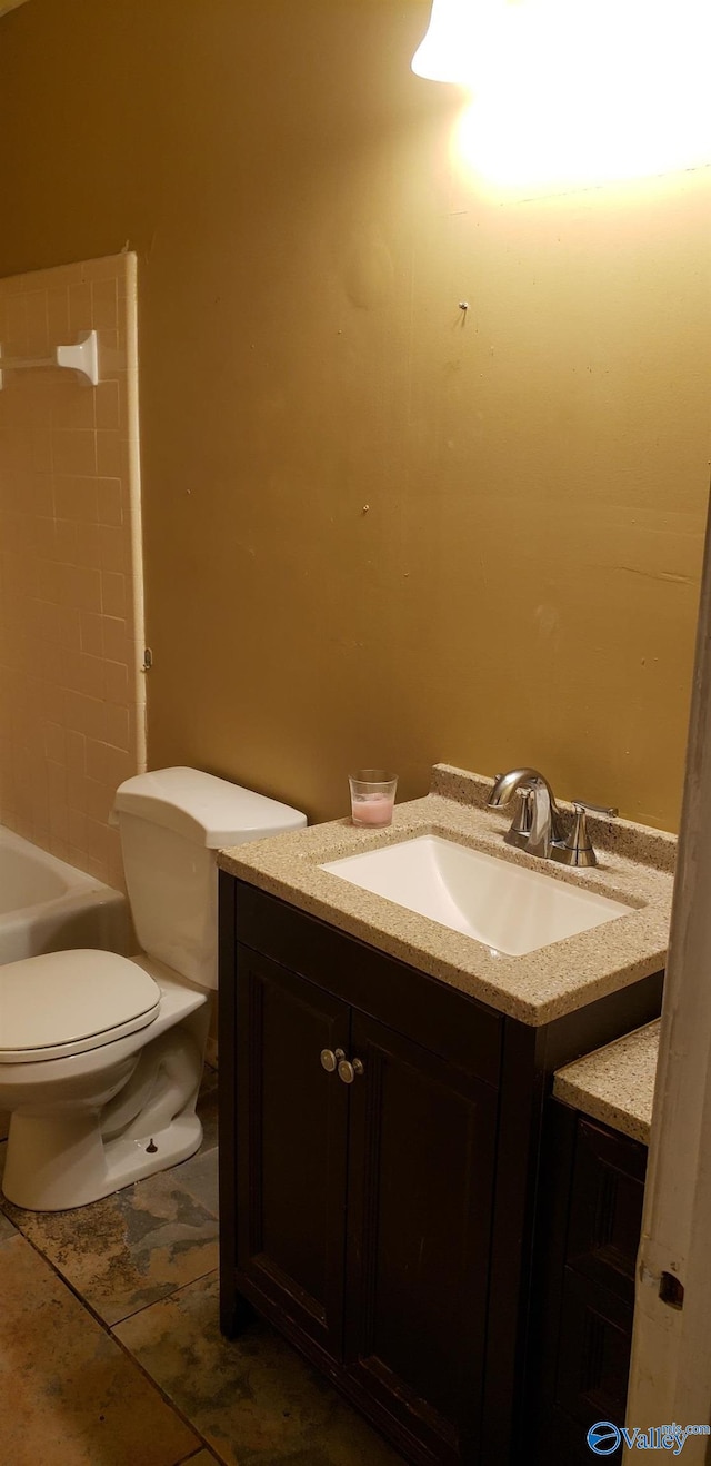 bathroom with vanity, tile patterned flooring, and toilet