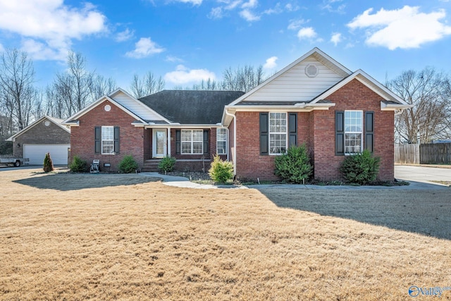 view of front of property featuring a garage and a front yard