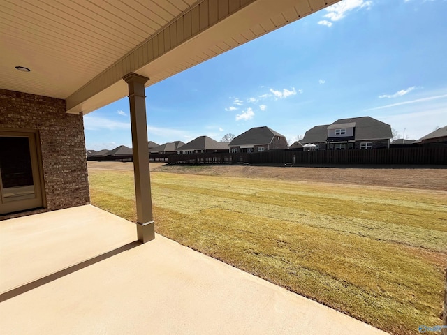 view of yard with a residential view and a patio